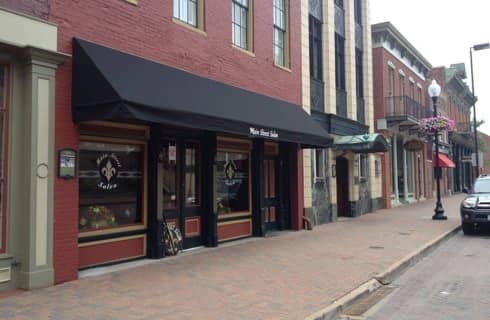 Store front with red brick and black awning
