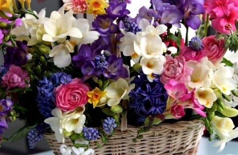 Wicker basked filled with beautiful white, purple, and pink flowers